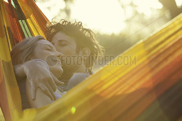 Affectionate couple relaxing together in hammock