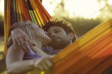 Couple relaxing together in hammock