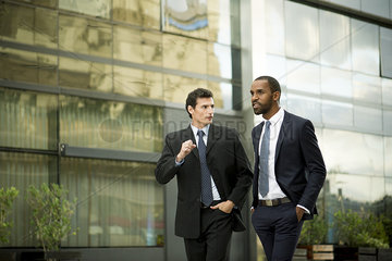 Businessmen walking and talking together