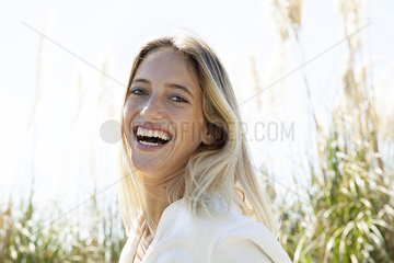 Woman laughing outdoors  portrait