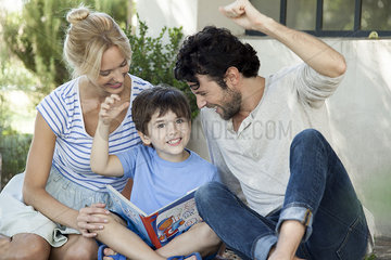 Parents teaching child to read