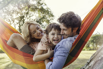 Family relaxing together on hammock  portrait