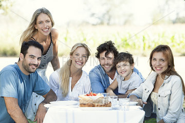 Family having picnic together outdoors  group portrait