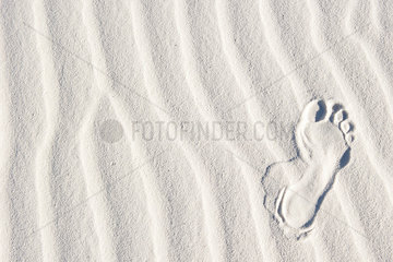 Footprint in white sand