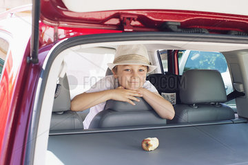 Boy looking out of back seat of car