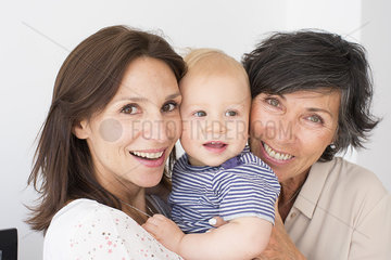 Smiling grandmother  mother and baby  portrait