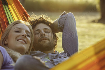 Couple relaxing together in hammock  portrait