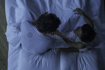 Couple being intimate in bed together