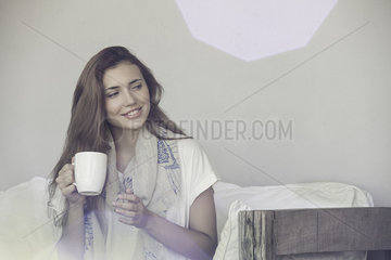 Woman enjoying solitude with cup of tea