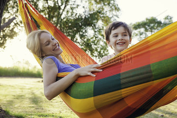 Mother and son relaxing together in hammock