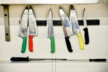 Knives hanging on magnectic strip