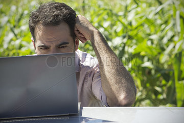 Man using laptop computer outdoors