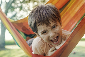 Boy lying in hammock  portrait