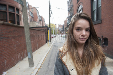 Teenage girl standing in alley  portrait
