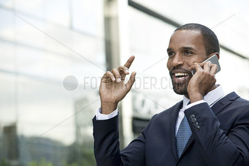 Businessman talking and laughing on cell phone