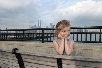 Little girl resting on pier near New York City  New York  USA