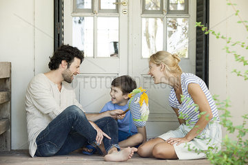 Family with one child having lighthearted time together outdoors