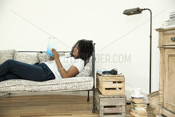 Woman relaxing at home with good book