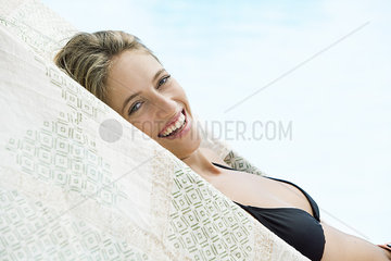 Woman sunbathing beside pool  portrait