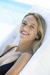 Woman relaxing beside pool  portrait