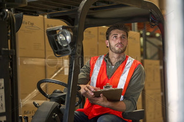 Worker sitting in forklift truck