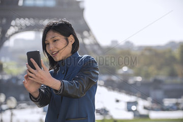 Woman taking selfie with smart phone