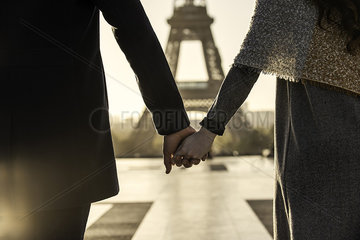 Couple walking towards Eiffel Tower