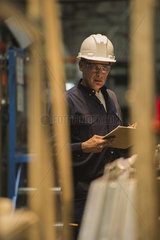 Factory worker with clipboard in factory