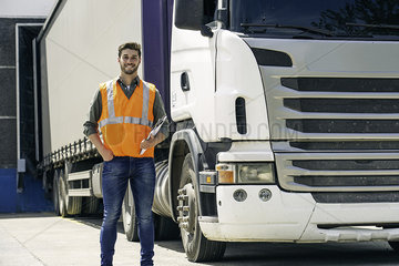 Worker standing in front of lorry