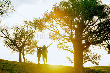 Couple enjoying nature  backlit by sunlight