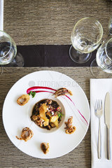 Seafood dish garnished with fried calamari