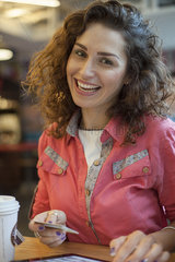 Woman making purchase wiith credit card  smiling  portrait