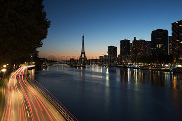 Light trails on a street along the River Seine at twilight  Paris  France