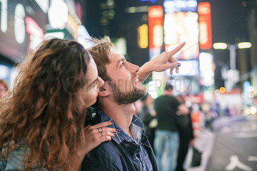 Young couple sightseeing in Times Square  New York City  New York  USA