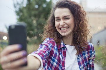 Young woman taking a selfie outdoors