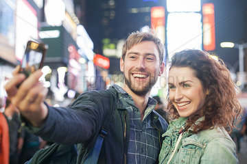 Young couple taking selfie in Times Square  New York City  New York  USA