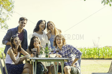 Friends posing for photo during outdoor meal together