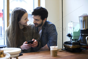 Couple relaxing together in coffee shop