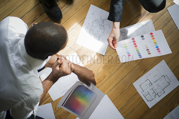 Couple discussing blueprints and color swatches