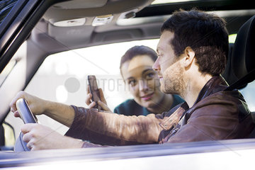 Couple on road trip using smartphone app to navigate