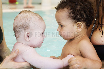 Children making friends at swimming pool