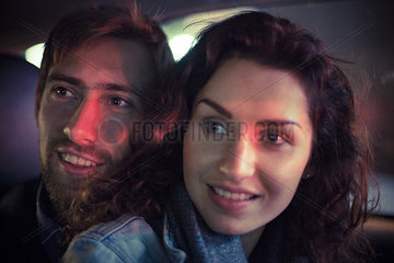 Couple looking out car window at night  portrait