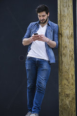 Young man text messaging on cell phone