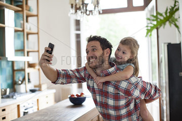 Father and daughter posing for selfie