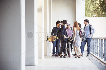 Group of college students chatting together after class