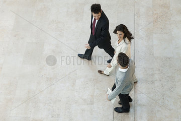 Business associates walking together in office lobby