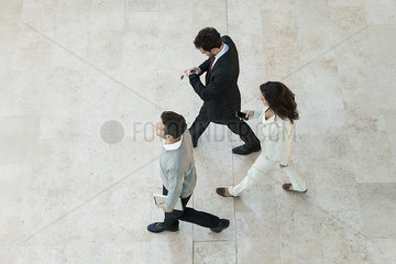 Business people walking through office lobby
