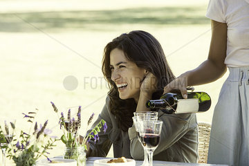 Woman enjoying meal with friend outdoors