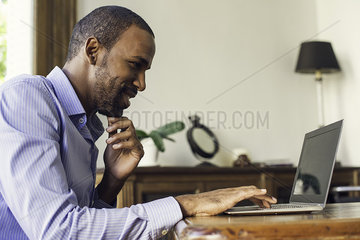 Man using laptop computer at home