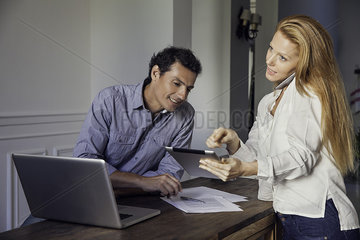 Couple working with wireless devices at home